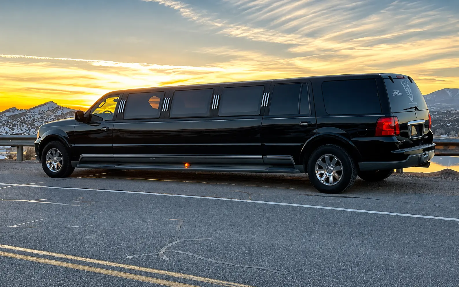 Black stretch limousine on the road at golden hour